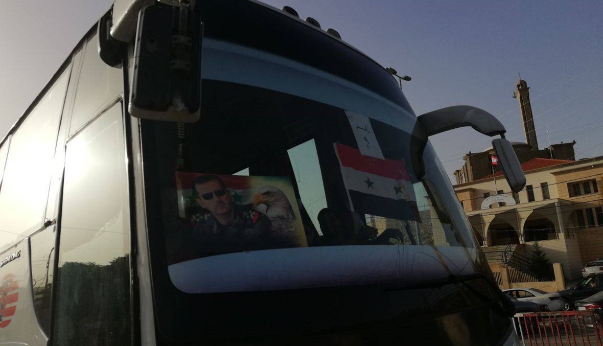 481 لاجئاً سورياً غادروا لبنان... العلم السوري رُفع فوق الباصات وصور الأسد ألصقت على زجاجها (صور)
