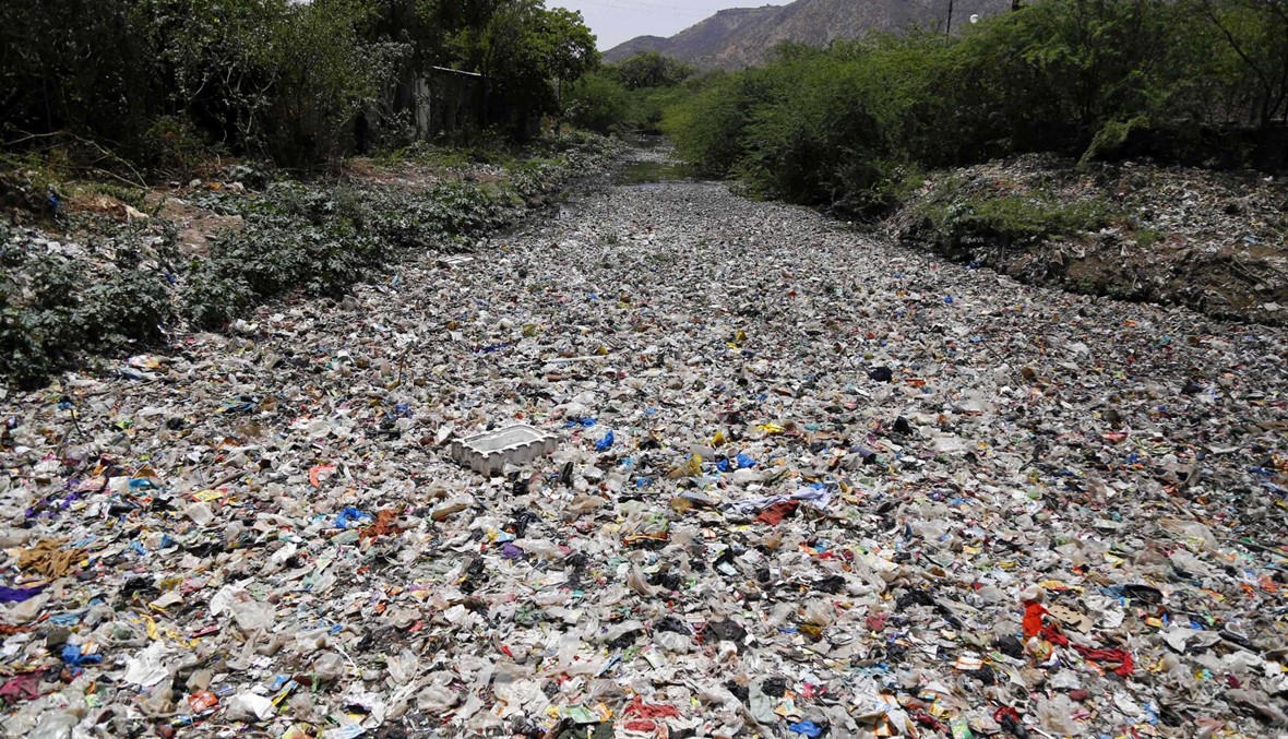 النفايات تطفو على أحد الأنهر في ولاية راجستان الهندية (أ ف ب).