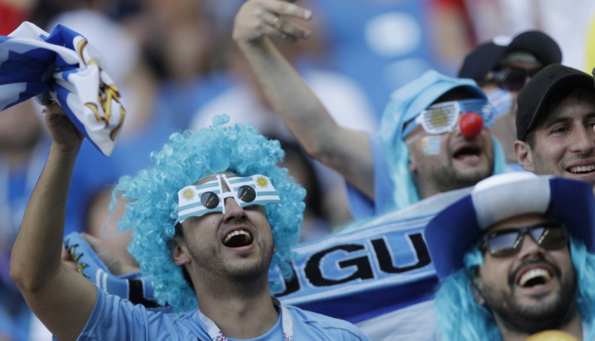 Uruguay tops Russia 3-0, wins group; both go on