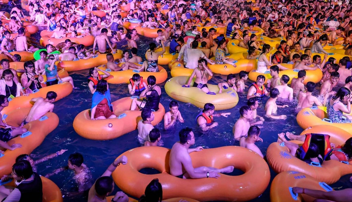 من دون تباعد وكمامات... آلاف الصينيين في ووهان يتحدون كورونا ويرقصون في الماء