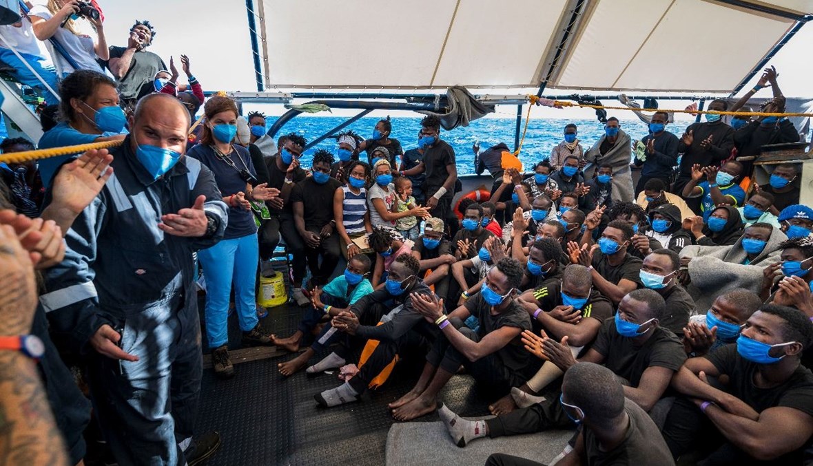 مهاجرون على متن سفينة الإنقاذ البحرية "سي ووتش 4" مع القبطان ستيفان نونكوفيتش (الى اليسار) قبالة سواحل صقلية بإيطاليا (1 أيلول 2020، أ ف ب).