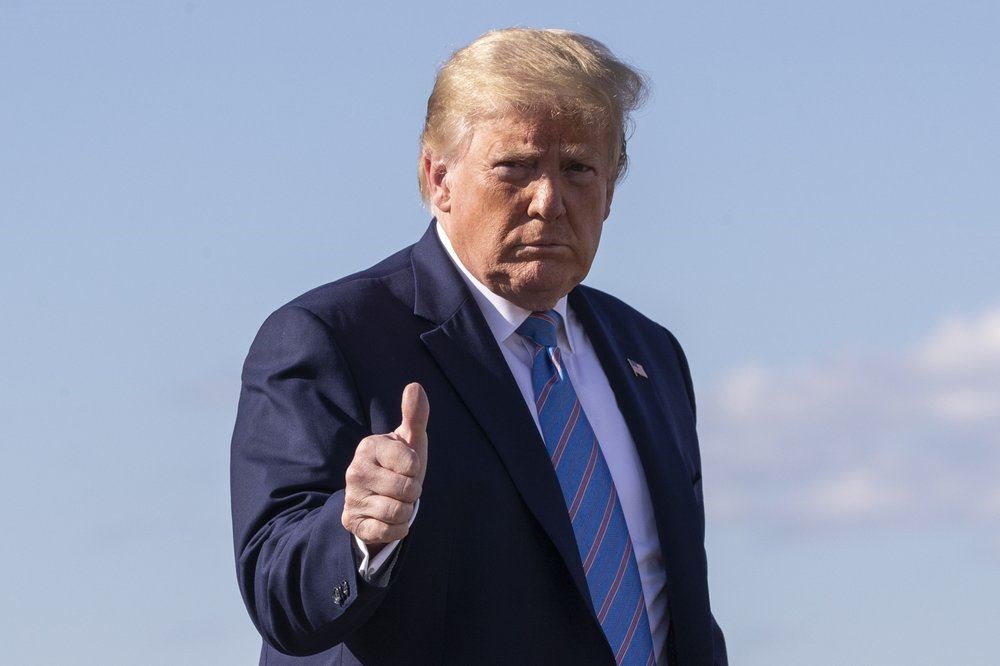 In this Sunday, June 14, 2020 file photo, President Donald Trump gives a thumbs-up while walking across the tarmac as he boards Air Force One at Morristown Municipal Airport, in Morristown, N.J. Trump is returning to Washington. (AP Photo)