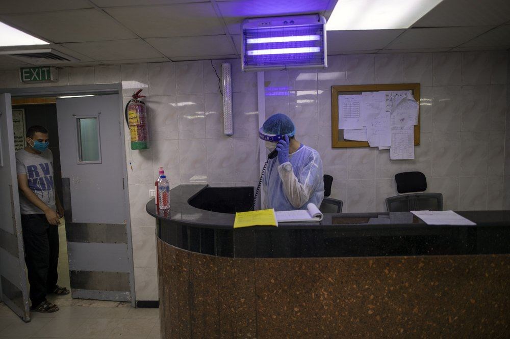 Palestinian doctors wear protective clothes as they work at the emergency room of the al-Quds Hospital in Gaza City, Monday, Sept. 7, 2020. Dozens of front-line health care workers have been infected, dealing a new blow to overburdened hospitals. (AP Photo)
