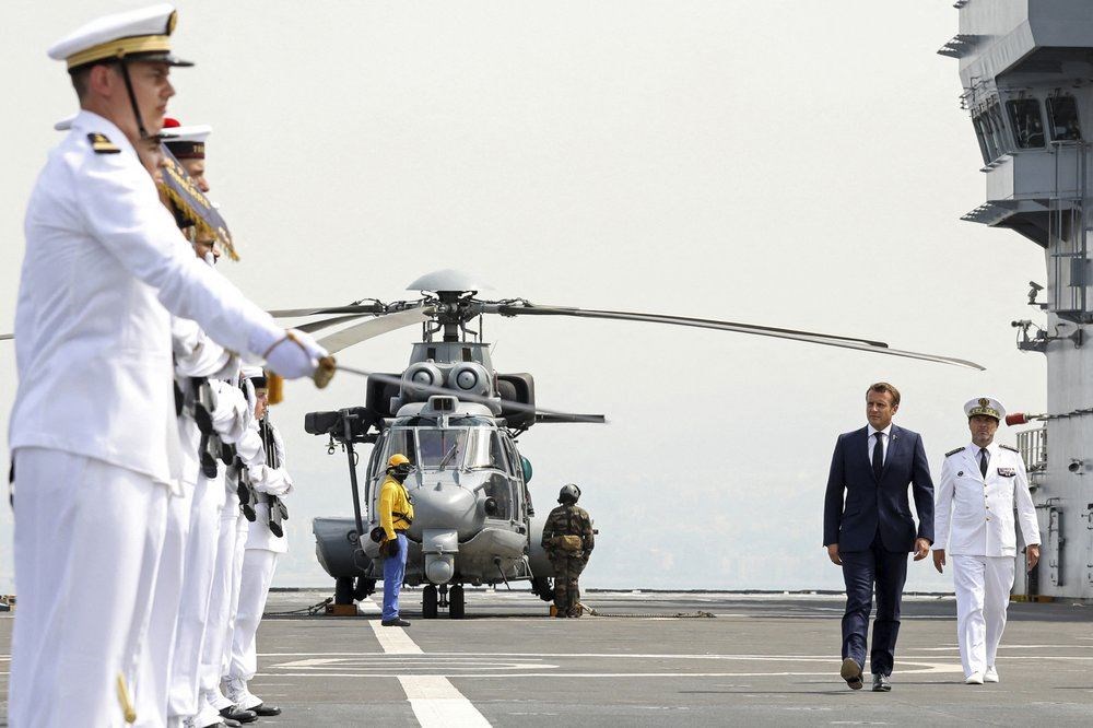 In this Sept. 1, 2020, file photo, French President Emmanuel Macron, second right, reviews the troops as he arrives on the French helicopter carrier Tonnerre, off the port of Beirut, Lebanon. (AP Photo)