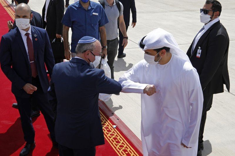 Israeli National Security Advisor Meir Ben-Shabbat, center left, elbow bumps with an Emirati official as he leaves Abu Dhabi, Arab Emirates, Tuesday, Sept. 1, 2020. (AP Photos)