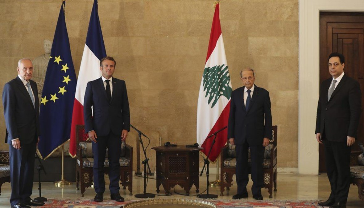French President Emmanuel Macron, second left, and Lebanese President Michel Aoun, second right, meet at Beirut–Rafic Hariri International Airport, in Lebanon, on Aug.6, 2020. (AP Photo)