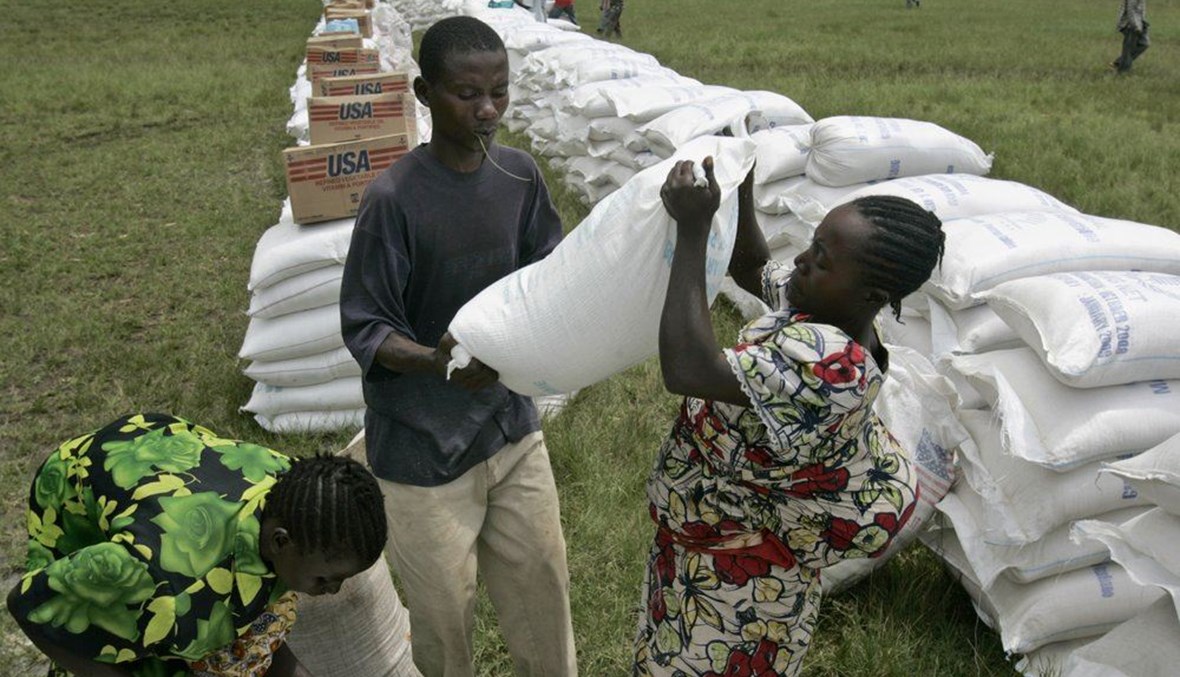 A woman receives a bag of maize meal from the World Food Program in the town of Rutshuru, eastern Congo on  Nov. 14, 2008. (AP Photo)