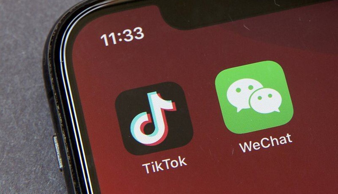  In this Friday, Aug. 7, 2020 file photo, Icons for the smartphone apps TikTok and WeChat are seen on a smartphone screen in Beijing. The U.S. government is cracking down on the Chinese apps TikTok and WeChat, starting by barring them from app stores on Sunday, Sept. 20, 2020. (AP Photo)