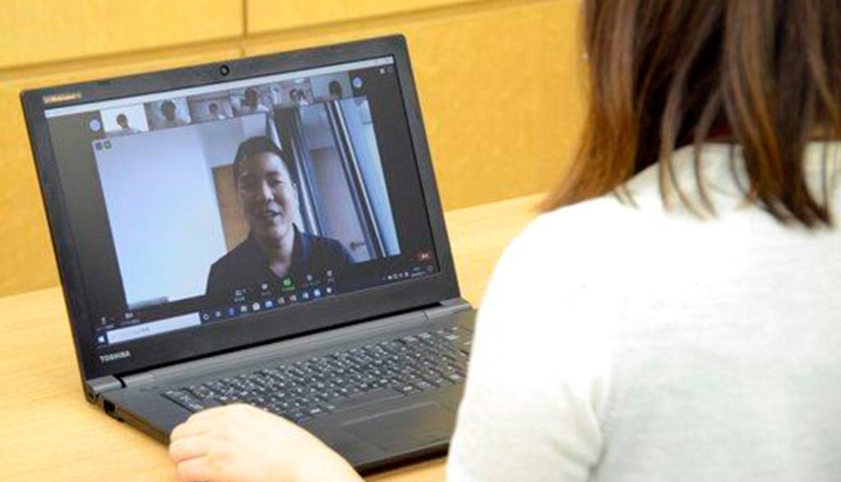 A college student attends an online course using Zoom. (AP Photo)