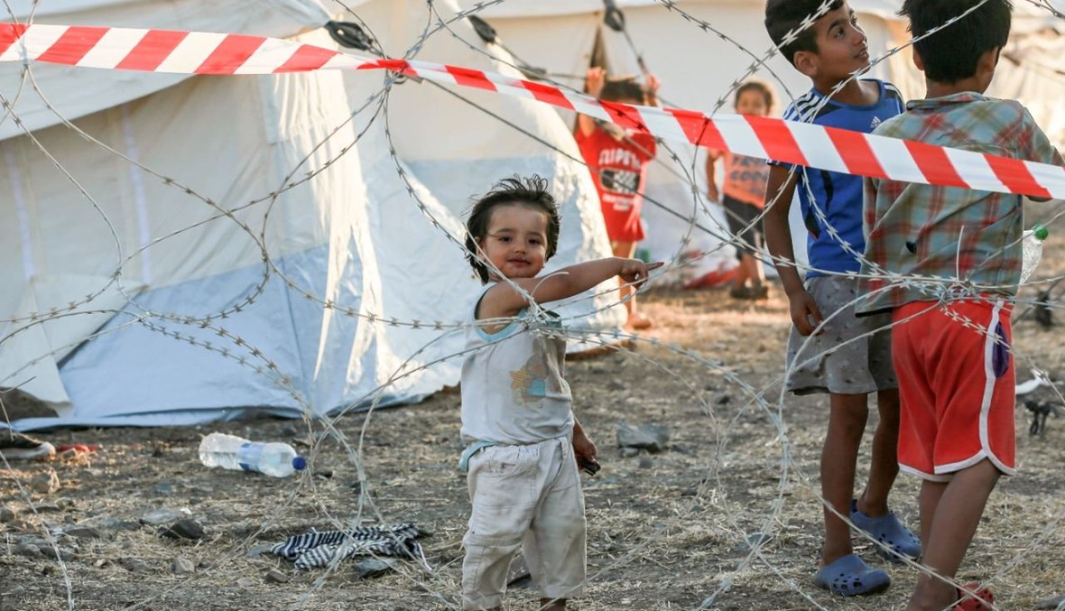 أطفال من عائلات مهاجرة في المخيم الموقت الجديد في جزيرة ليسبوس اليونانية (19 أيلول 2020، أ ف ب). 