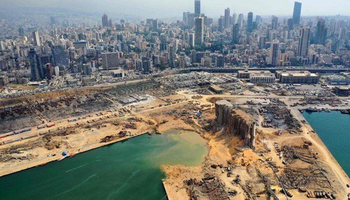 Above, an aerial view taken on August 7, 2020 shows a partial view of the port of Beirut and the crater caused by the explosion. (AFP)