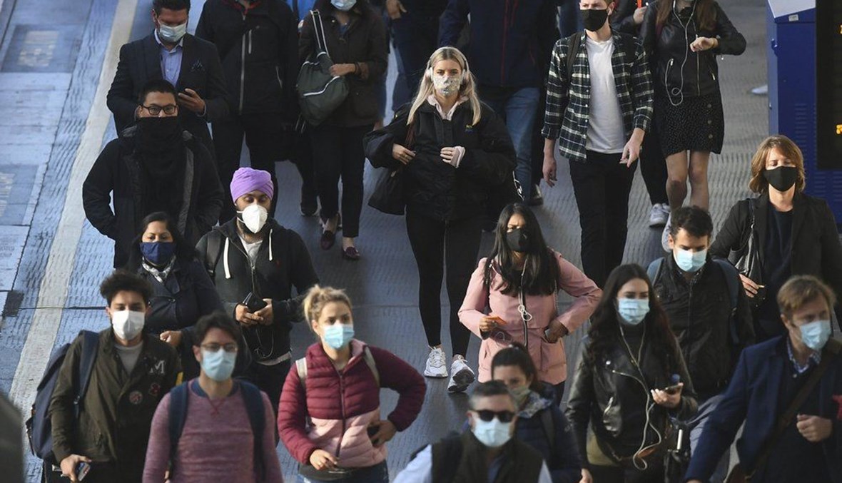 Commuters at Waterloo Station, in London, Thursday, Sept. 24, 2020, after Britain's Prime Minister Boris Johnson announced a range of new restrictions to combat the rise in coronavirus cases in England. (AP Photo)