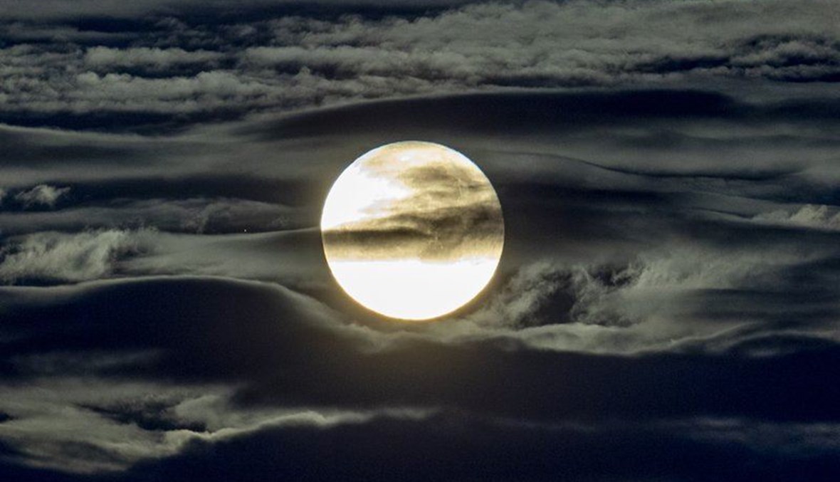 The full moon shines surrounded by clouds in the outskirts of Frankfurt, Germany on Sept. 2, 2020. (AP Photo)