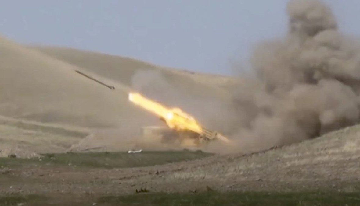 In this image taken from footage released by Azerbaijan's Defense Ministry on Sunday, Sept. 27, 2020, an Azerbaijan's rocket launches from missile system at the contact line of the self-proclaimed Republic of Nagorno-Karabakh, Azerbaijan. (AP Photo) 