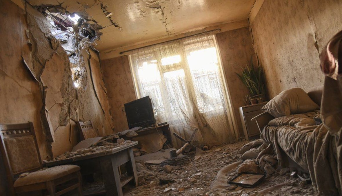 Damages are seen inside an apartment in a residential area after shelling during a military conflict in self-proclaimed Republic of Nagorno-Karabakh, Stepanakert, Azerbaijan, Saturday, Oct. 3, 2020. (AP Photo)