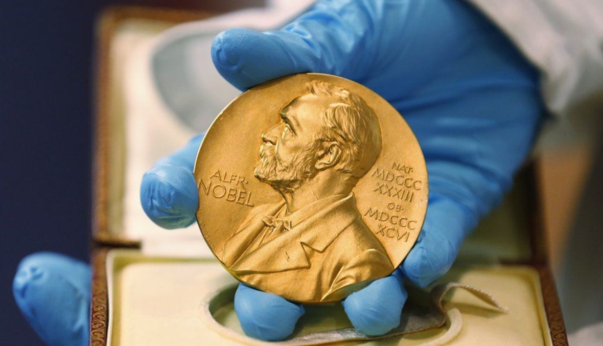 In this April 17, 2015, a national library employee shows a gold Nobel Prize medal in Bogota, Colombia.  (AP Photo)