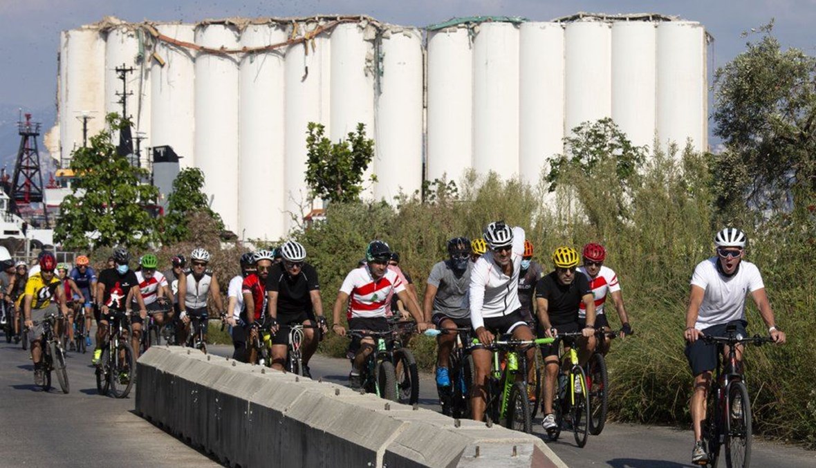 Former American professional cyclist Lance Armstrong, right, rides with Lebanese and foreign cyclists at the site of the Aug. 4 deadly blast in the port of Beirut, on Oct. 4, 2020. (AP Photo)