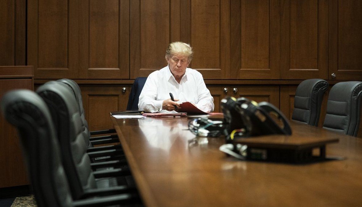 In this image released by the White House, President Donald Trump works in his conference room at Walter Reed National Military Medical Center in Bethesda, Md., Saturday, Oct. 3, 2020. (AP Photo)