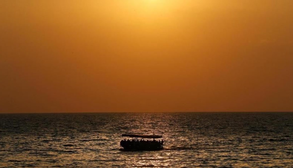 A boat carrying migrants sails off the coast of the northern Lebanese city of Tripoli. (AP Photo)
