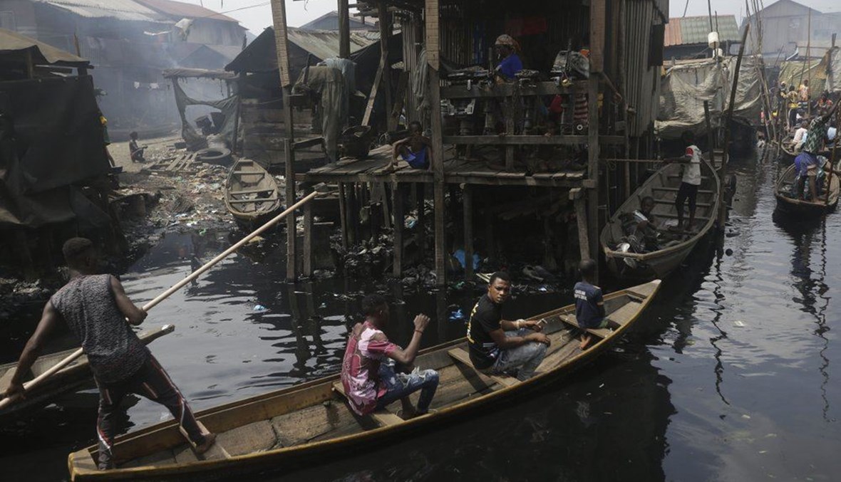In this Saturday, March 21, 2020 file photo, people travel by canoe during a coronavirus lockdown in the floating slum of Makoko in Lagos, Nigeria. (AP Photo)