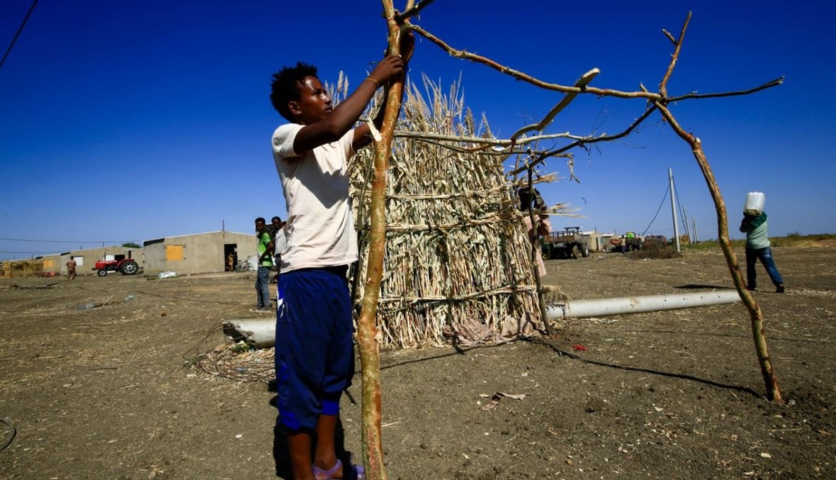 لاجئ إثيوبي يبني مأوى في مركز استقبال حدودي في ولاية القضارف شرق السودان (29 ت2 2020، أ ف ب).