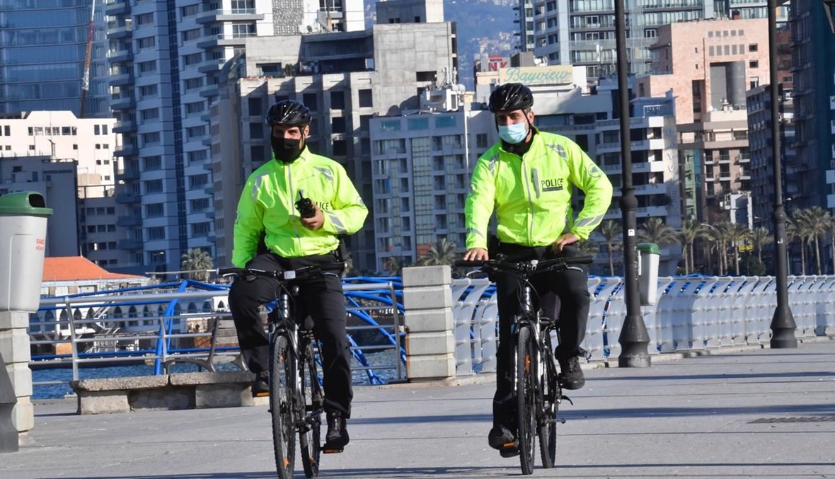 أفراد من الشرطة على الدراجات الهوائية يراقبون تطبيق قرار الاقفال العام عند الكورنيش البحري لبيروت. (حسن عسل)