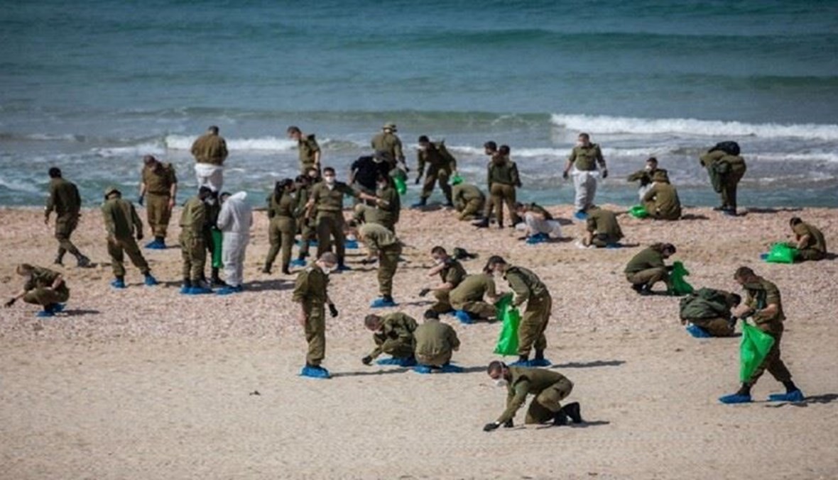 جنود اسرائيليون يشاركون في تنظيف الشاطىء.