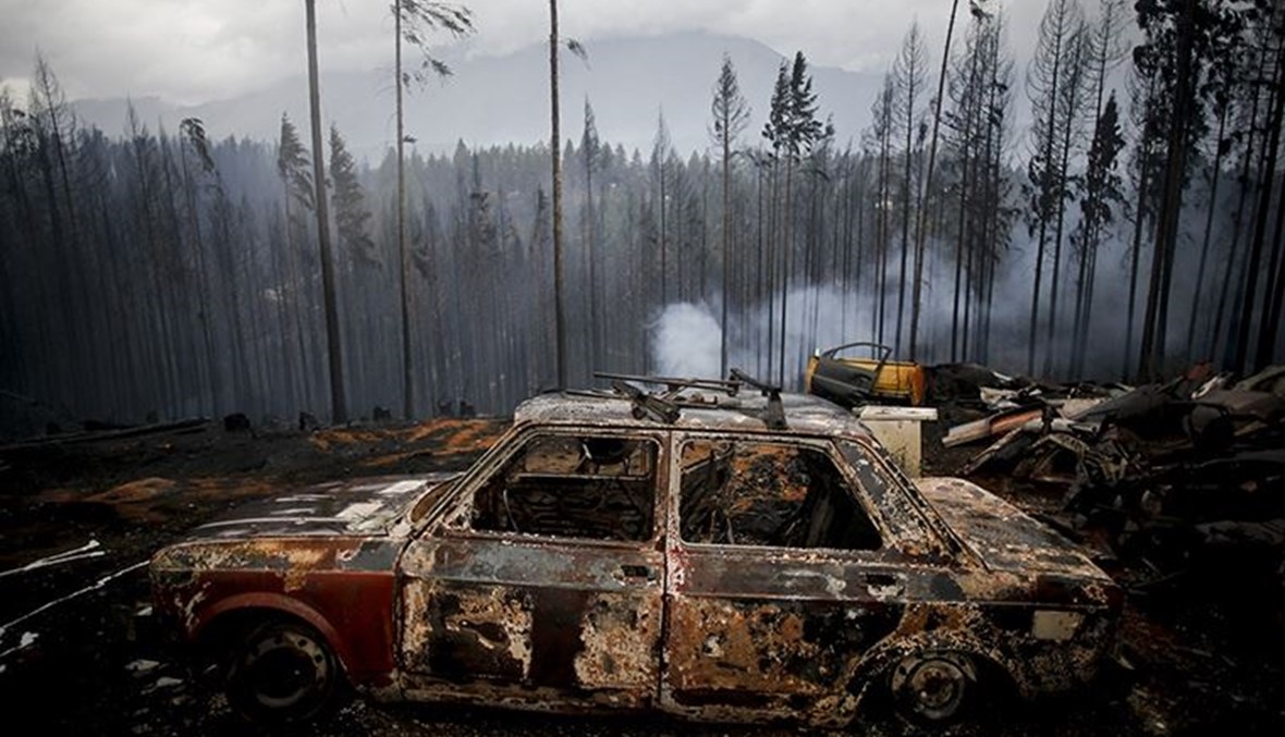 سيارة محترقة في الغابات التي أكلتها النيران (ا ب)