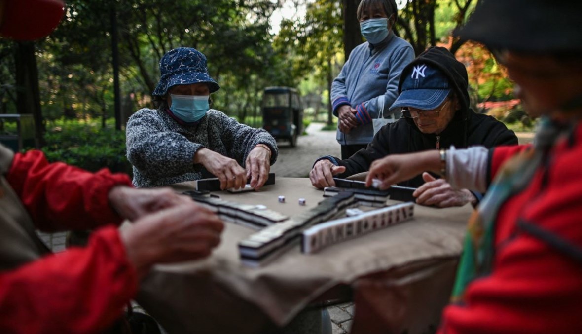 مسنون يتشاركون في لعبة في حديقة تشونغشان في شنغهاي بالصين (8 نيسان 2021، أ ف ب). 