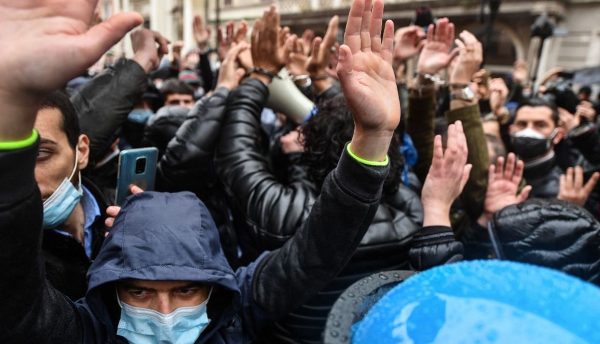 أشخاص يحتجون على قيود كورونا في ساحة سان سيلفسترو في وسط روما (12 نيسان 2021، أ ف ب). 