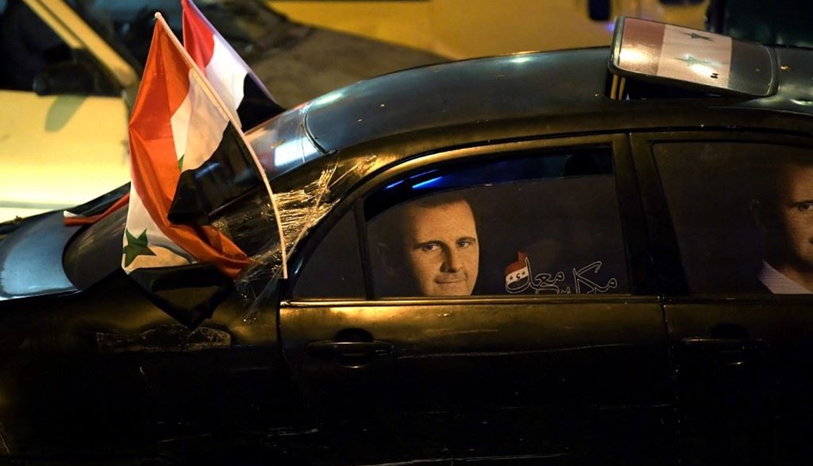 يحتفل السوريون في شوارع حلب بإعادة انتخاب الرئيس بشار الأسد لولاية رابعة كرئيس لسوريا (أ ف ب). 