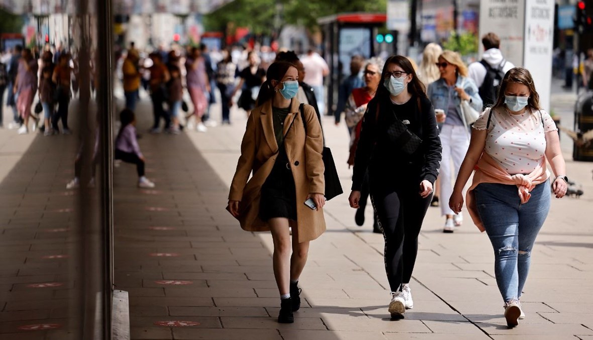أشخاص يمشون في شارع أكسفورد في وسط لندن (6 حزيران 2021، أ ف ب).
