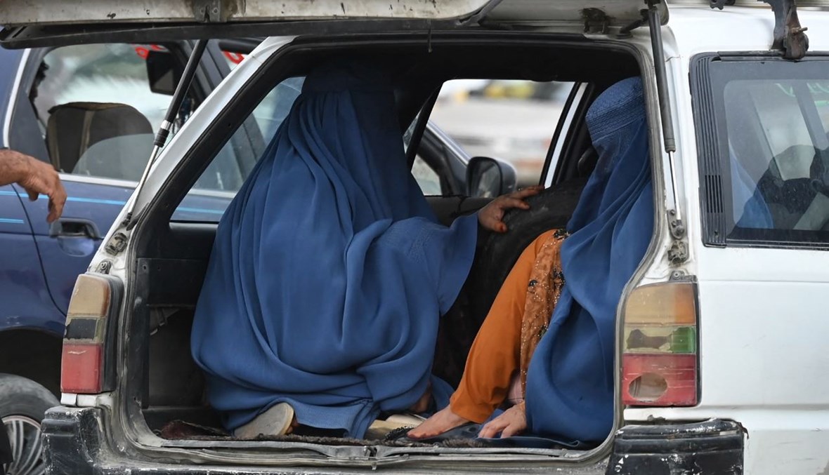 نساء بالبرقع يجلسن داخل سيارة أجرة محلية في كابول (31 تموز 2021، ا ف ب). 