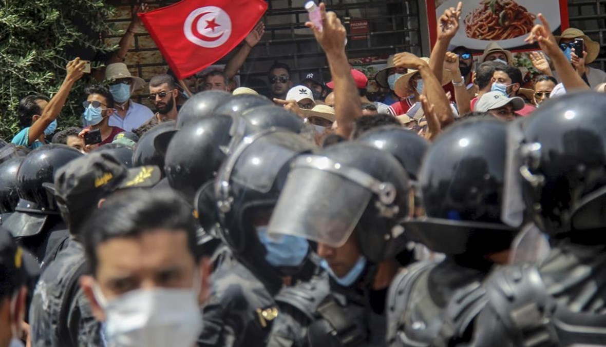 متظاهرون في مواجهة شرطيين خلال تظاهرة في تونس العاصمة (25 تموز 2021، أ ب). 