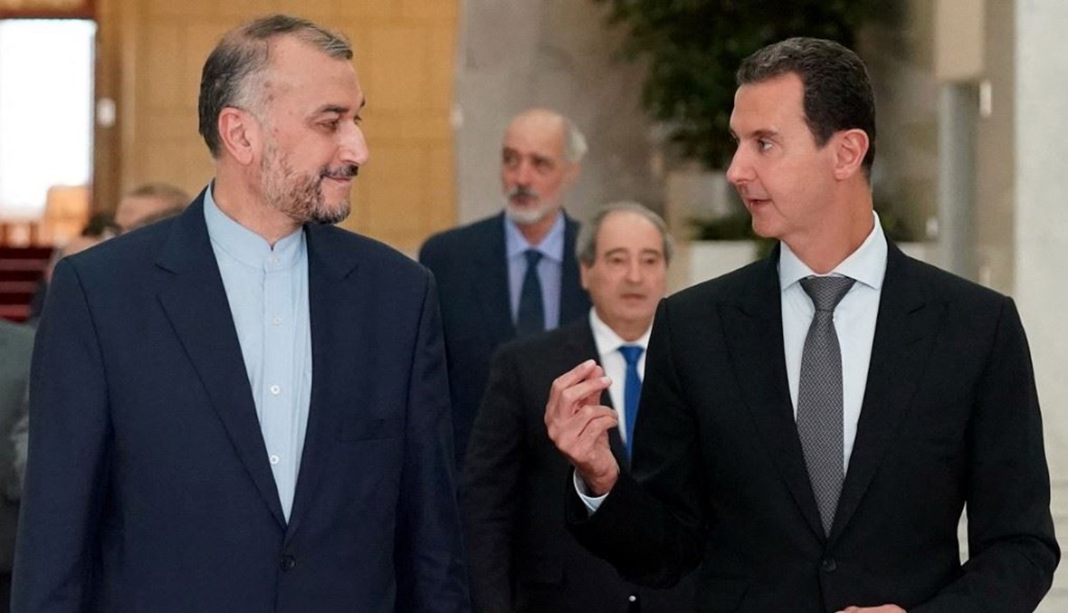 الأسد ووزير الخارجية الإيراني (ا ف ب)