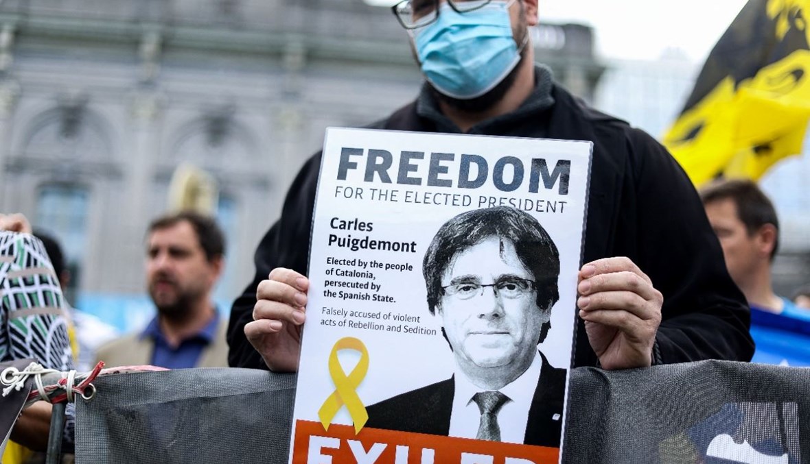 متظاهر يحمل صورة بوتشيمون خلال تظاهرة بالقرب من البرلمان الأوروبي في بروكسيل (24 ايلول 2021، أ ف ب). 