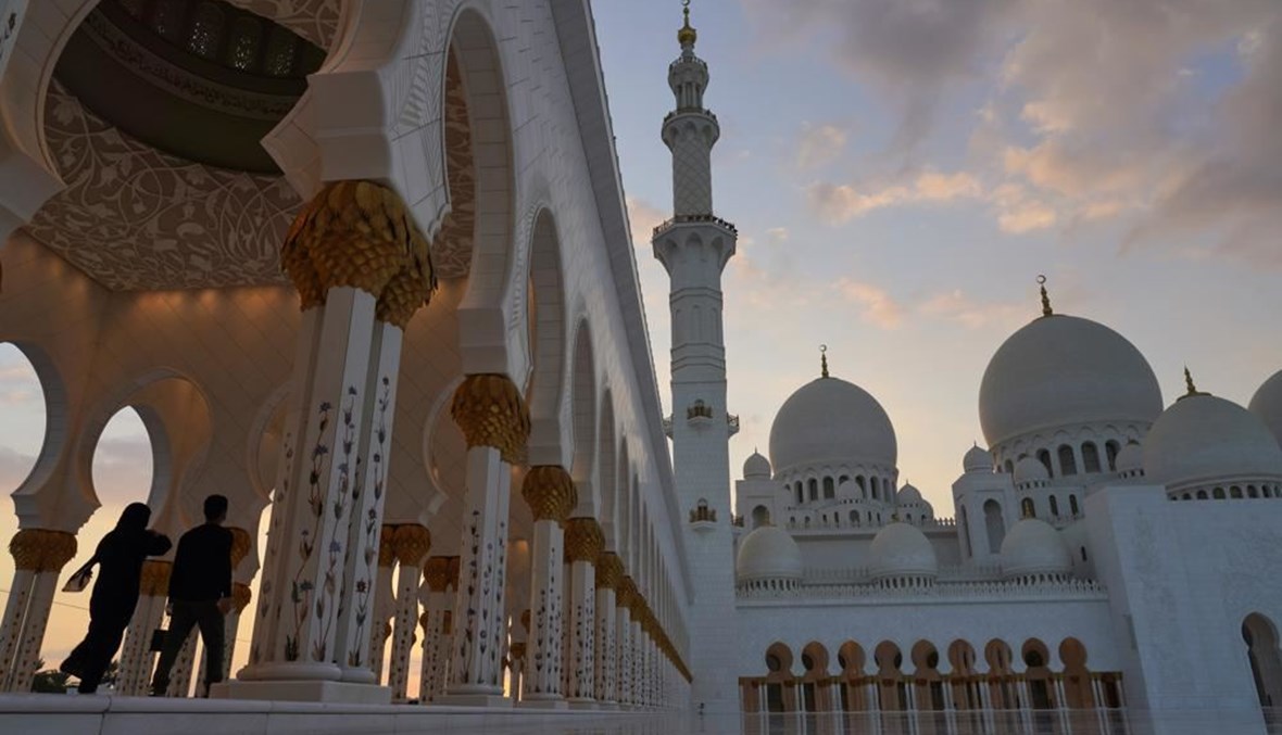 سيّاح يمشون في مسجد الشيخ زايد الكبير في أبوظبي (9 ك1 2020، أ ب). 