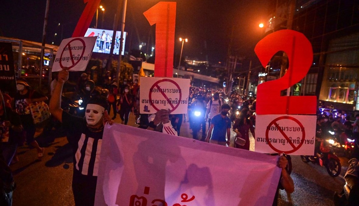 تايلانديون يشاركون في تظاهرة في بانكوك (14 ت2 2021، أ ف ب). 
