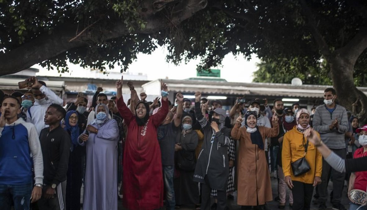 متظاهرون يرددون هتافات في الرباط خلال احتجاج على اعتماد جواز التطعيم الالزامي (21 ت1 2021، أ ب). 