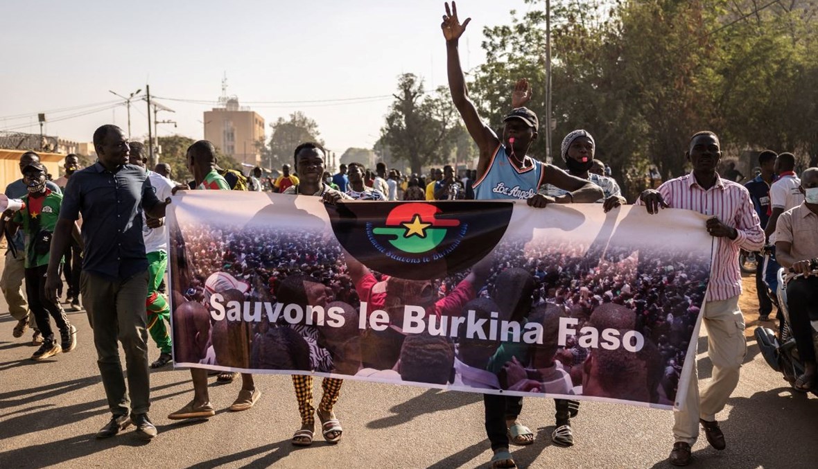 متظاهرون يحملون لافتة كتب عليها "أنقذوا بوركينا فاسو" خلال تظاهرة في واغادوغو (27 ت2 2021، أ ف ب). 