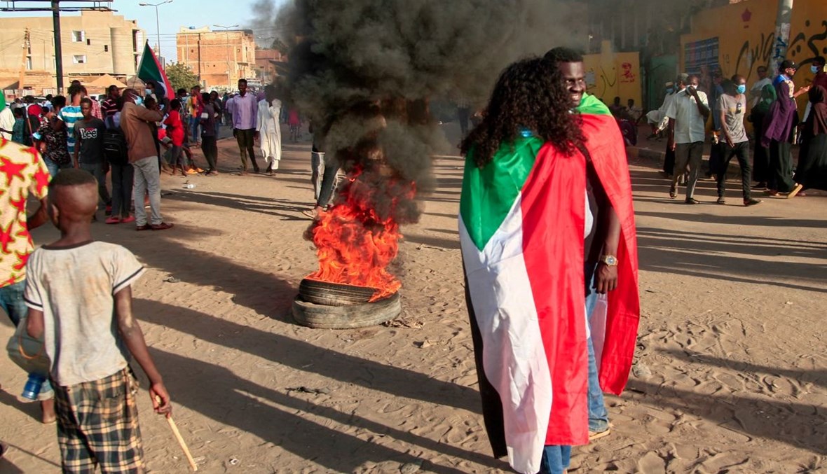سودانيون يشاركون في احتجاج في أم درمان، للمطالبة بحكم مدني  (13 ك1 2021، ا ف ب). 
