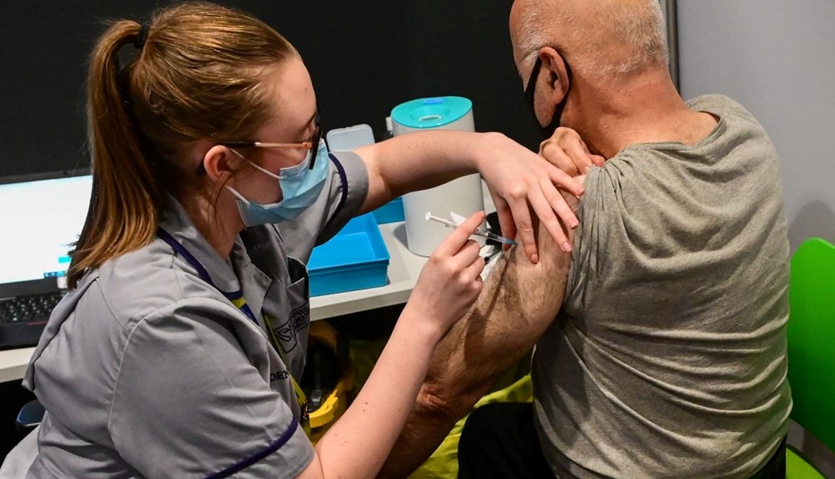  رجل يتلقى لقاح كورونا في مركز تطعيم في مستشفى الدر هاي للأطفال في ليفربول في انكلترا (20 ك1 2021، ا ف ب). 