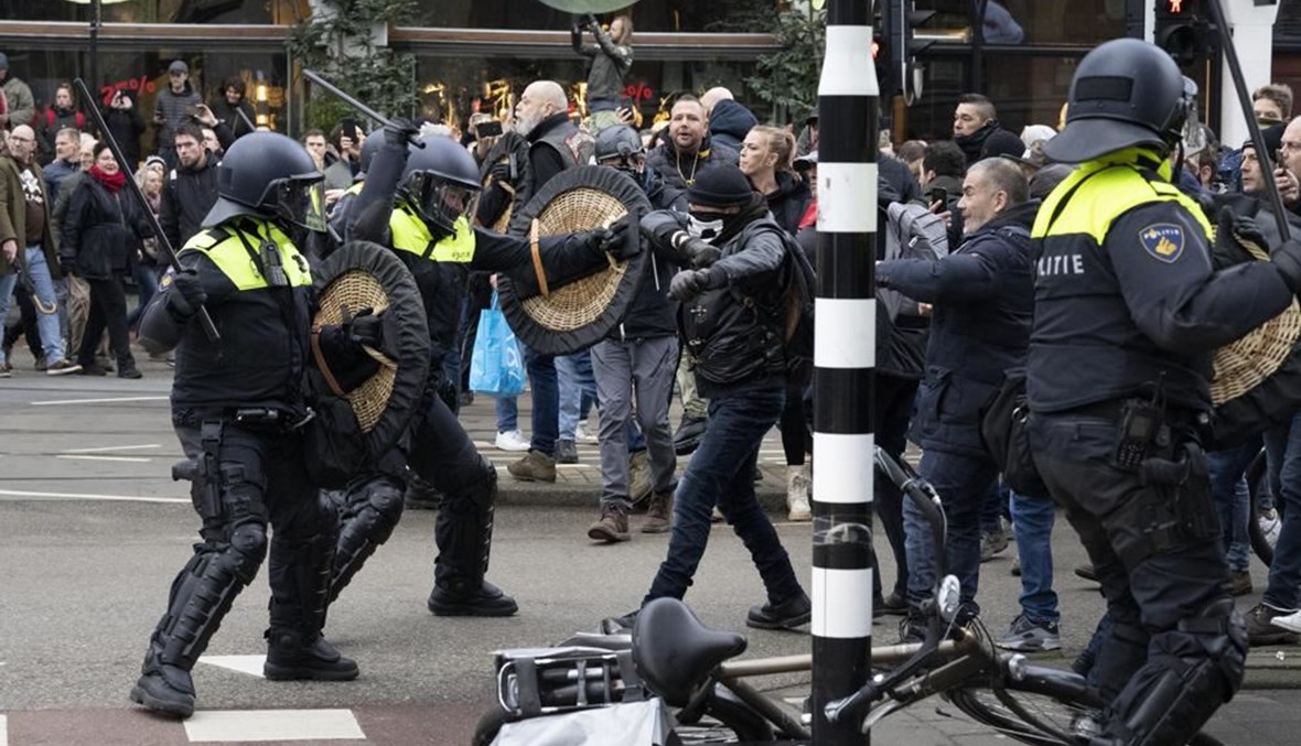 عناصر من الشرطة يشتبكون مع متظاهرين في أمستردام (2 ك2 2022، أ ب). 